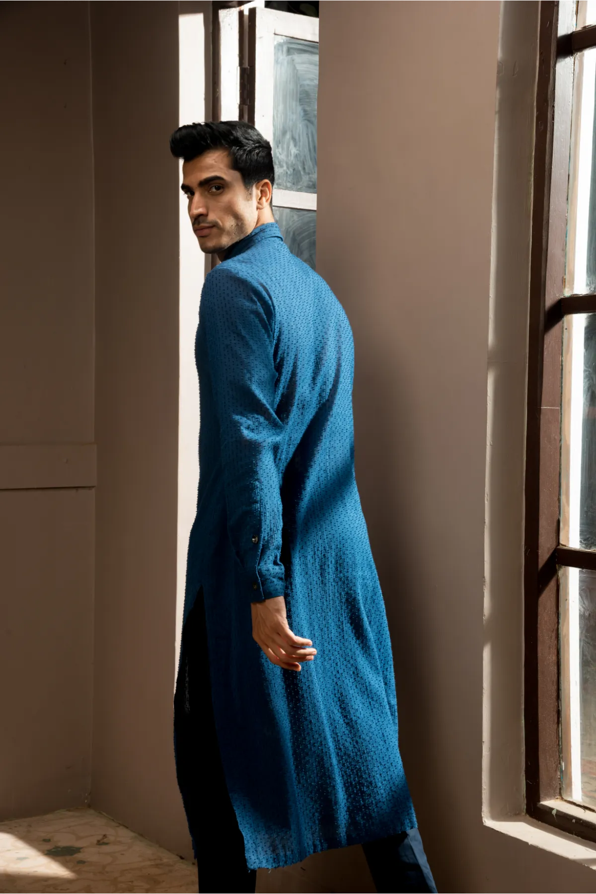 Dark blue textured sherwani with blue long kurta and pleated trousers